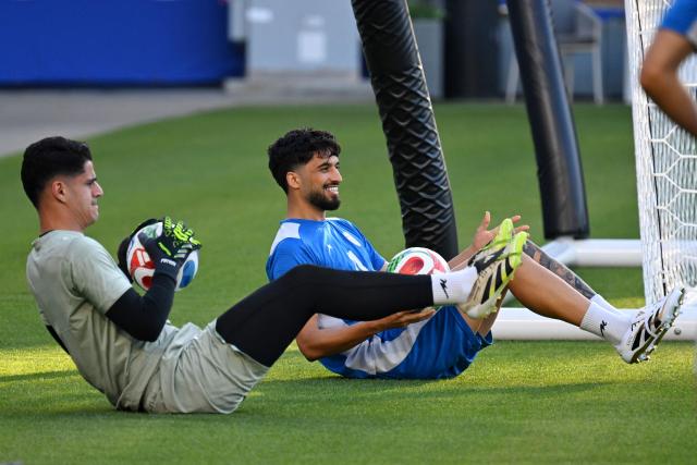 Iran's goalkeeper #12 Payam Niazmand and Iran's forward #11 Ali Alipour take part in a training session at Carson Sports Park in Carson, California on June 14, 2026, on the eve of the 2026 World Cup football match between Iran and New Zealand.  (Photo by Patrick T. Fallon / AFP)
