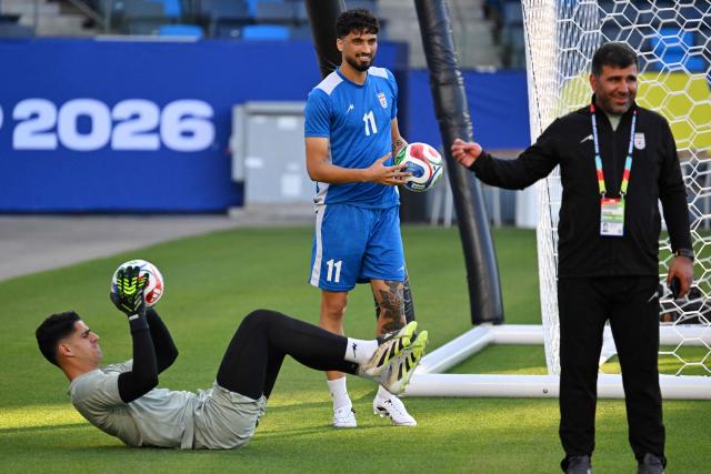 Iran's goalkeeper #12 Payam Niazmand and Iran's forward #11 Ali Alipour take part in a training session at Carson Sports Park in Carson, California on June 14, 2026, on the eve of the 2026 World Cup football match between Iran and New Zealand.  (Photo by Patrick T. Fallon / AFP)
