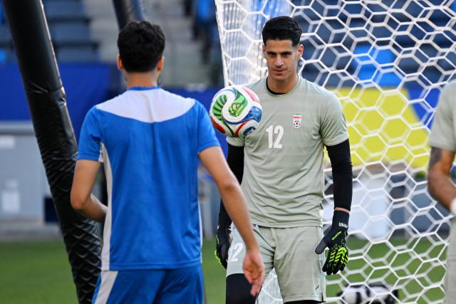 Iran's forward #11 Ali Alipour and goalkeeper #12 Payam Niazmand take part in a training session at Carson Sports Park in Carson, California on June 14, 2026, on the eve of the 2026 World Cup football match between Iran and New Zealand.  (Photo by Patrick T. Fallon / AFP)