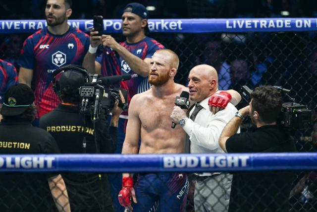 Joe Rogan (R) interviews America's Bo Nickal after Nickal defeated America's Kyle Daukaus during the "UFC Freedom 250" mixed martial arts event on the South Lawn of the White House in Washington, DC, June 14, 2026. (Photo by Kent NISHIMURA / AFP)