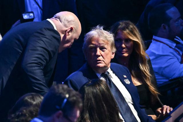 (L/R) UFC President Dana White speaks with US President Donald Trump alongside First Lady Melania Trump as they attend the "UFC Freedom 250" mixed martial arts event on the South Lawn of the White House in Washington, DC, June 14, 2026. (Photo by Kent NISHIMURA / AFP)