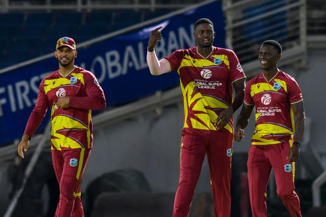 Jason Holder (C), Brandon King (L) and Shamar Joseph (R) of West Indies celebrate the dismissal of Dasun Shanaka of Sri Lanka during the third Twenty20 (T20) international cricket match between West Indies and Sri Lanka at Sabina Park in Kingston, Jamaica, on June 14, 2026. (Photo by Randy Brooks / AFP)