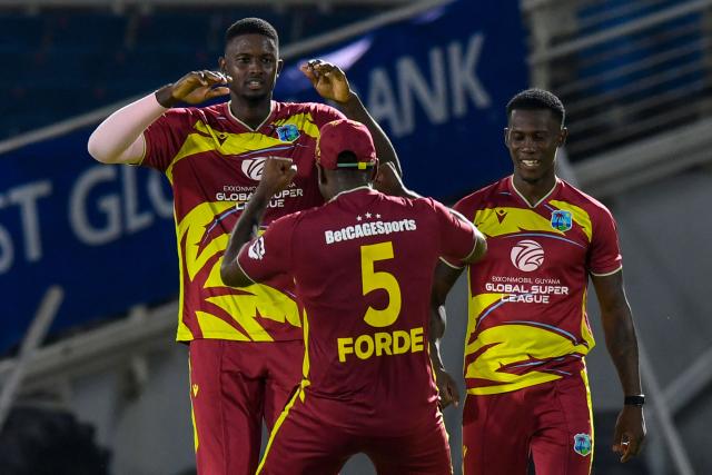 Jason Holder (L) and Shamar Joseph (R) of West Indies celebrate the dismissal of Dasun Shanaka of Sri Lanka during the third Twenty20 (T20) international cricket match between West Indies and Sri Lanka at Sabina Park in Kingston, Jamaica, on June 14, 2026. (Photo by Randy Brooks / AFP)