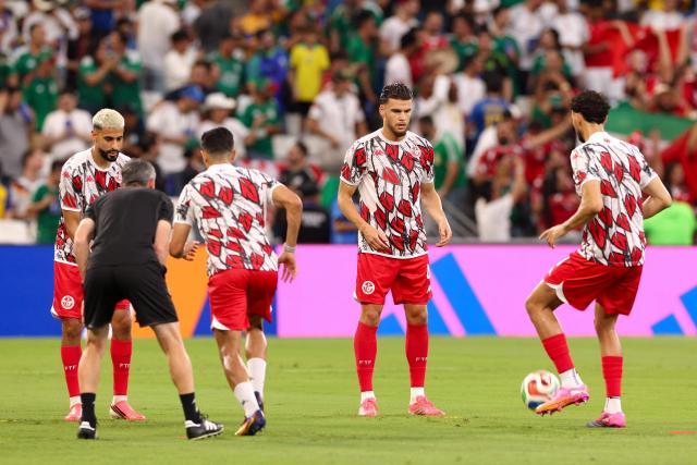 Tunisia's players take part in the warm-up ahead of the 2026 World Cup Group F football match between Sweden and Tunisia at the Monterrey Stadium in Guadalupe on June 14, 2026.  (Photo by Julio Cesar AGUILAR / AFP)