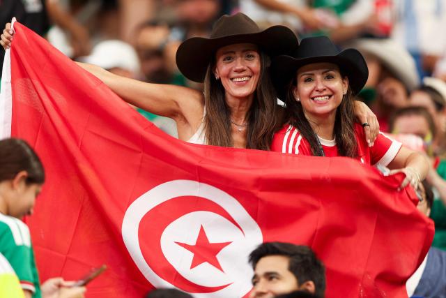 Tunisian's fans hold a national flag ahead of the 2026 World Cup Group F football match between Sweden and Tunisia at the Monterrey Stadium in Guadalupe on June 14, 2026.  (Photo by Julio Cesar AGUILAR / AFP)