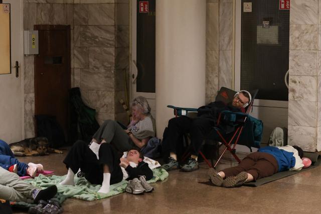 People shelter in a metro station during a Russian missile strike on the Ukrainian capital Kyiv on June 15, 2026, amid the Russian invasion in Ukraine. A major missile attack struck Kyiv early on June 15, an AFP reporter witnessed, with projectiles intercepted in the sky and glowing debris falling onto the city. Ukrainian officials including the city's mayor Vitali Klitschko reported on Telegram that strikes hit various districts. (Photo by Serhii Okunev / AFP)