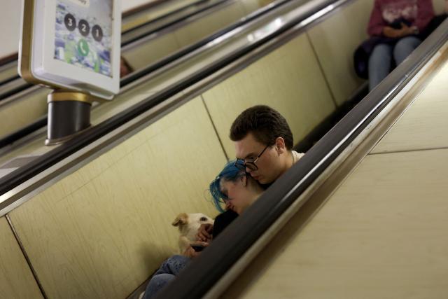 People and their pet shelter in a metro station during a Russian missile strike on the Ukrainian capital Kyiv on June 15, 2026, amid the Russian invasion in Ukraine. A major missile attack struck Kyiv early on June 15, an AFP reporter witnessed, with projectiles intercepted in the sky and glowing debris falling onto the city. Ukrainian officials including the city's mayor Vitali Klitschko reported on Telegram that strikes hit various districts. (Photo by Serhii Okunev / AFP)
