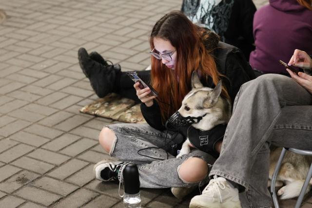 A person shelters with her pet dog in a metro station during a Russian missile strike on the Ukrainian capital Kyiv on June 15, 2026, amid the Russian invasion in Ukraine. A major missile attack struck Kyiv early on June 15, an AFP reporter witnessed, with projectiles intercepted in the sky and glowing debris falling onto the city. Ukrainian officials including the city's mayor Vitali Klitschko reported on Telegram that strikes hit various districts. (Photo by Serhii Okunev / AFP)