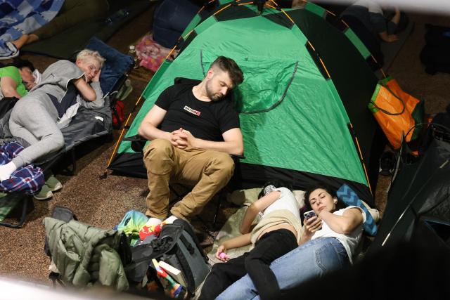 People shelter in a metro station during a Russian missile strike on the Ukrainian capital Kyiv on June 15, 2026, amid the Russian invasion in Ukraine. A major missile attack struck Kyiv early on June 15, an AFP reporter witnessed, with projectiles intercepted in the sky and glowing debris falling onto the city. Ukrainian officials including the city's mayor Vitali Klitschko reported on Telegram that strikes hit various districts. (Photo by Serhii Okunev / AFP)