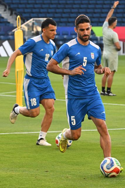 Iran's forward #18 Amirhossein Hosseinzadeh and defender #05 Milad Mohammadi take part in a training session at Carson Sports Park in Carson, California on June 14, 2026, on the eve of the 2026 World Cup football match between Iran and New Zealand.  (Photo by Patrick T. Fallon / AFP)