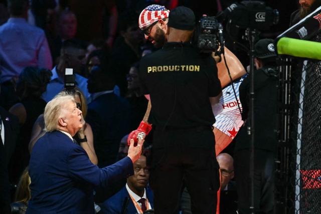 US President Donald Trump shakes hands with America's Josh Hokit during the "UFC Freedom 250" mixed martial arts event on the South Lawn of the White House in Washington, DC, June 14, 2026. (Photo by Kent NISHIMURA / AFP)