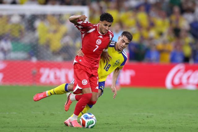 Tunisia's forward #07 Elias Achouri and Sweden's midfielder #18 Yasin Ayari fight for the ball during the 2026 World Cup Group F football match between Sweden and Tunisia at the Monterrey Stadium in Guadalupe on June 14, 2026.  (Photo by Julio Cesar AGUILAR / AFP)