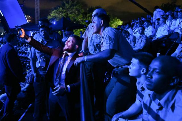 Brazilian former mixed martial artist and kickboxer Alex Pereira takes pictures with and greets members of the US military during the "UFC Freedom 250" mixed martial arts event on the South Lawn of the White House in Washington, DC, June 14, 2026. (Photo by Kent NISHIMURA / AFP)
