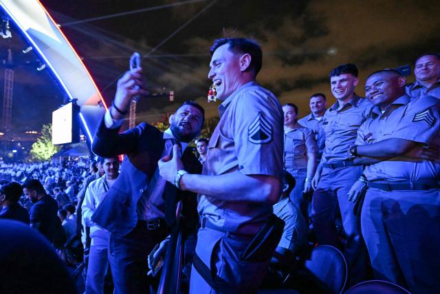 Brazilian former mixed martial artist and kickboxer Alex Pereira takes pictures with and greets members of the US military during the "UFC Freedom 250" mixed martial arts event on the South Lawn of the White House in Washington, DC, June 14, 2026. (Photo by Kent NISHIMURA / AFP)