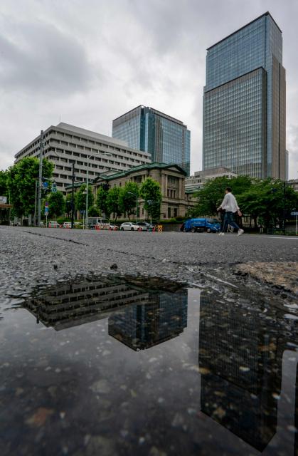 The Bank of Japan headquarters building (C) is seen in Tokyo on June 15, 2026. The Bank of Japan is scheduled to hold a two-day policy meeting from June 15. (Photo by Kazuhiro NOGI / AFP)
