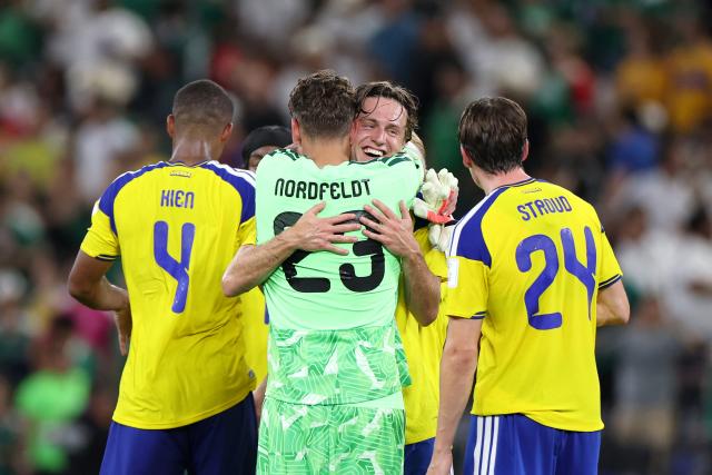 Sweden's goalkeeper #23 Kristoffer Nordfeldt celebrates with a temamate after winning the 2026 World Cup Group F football match between Sweden and Tunisia at the Monterrey Stadium in Guadalupe on June 14, 2026.  (Photo by Julio Cesar AGUILAR / AFP)