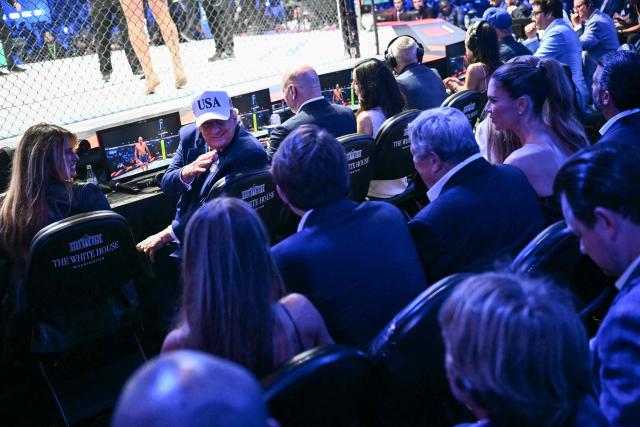US President Donald Trump sits with First Lady Melania Trump during the "UFC Freedom 250" mixed martial arts event on the South Lawn of the White House in Washington, DC, June 14, 2026. (Photo by Kent NISHIMURA / AFP)