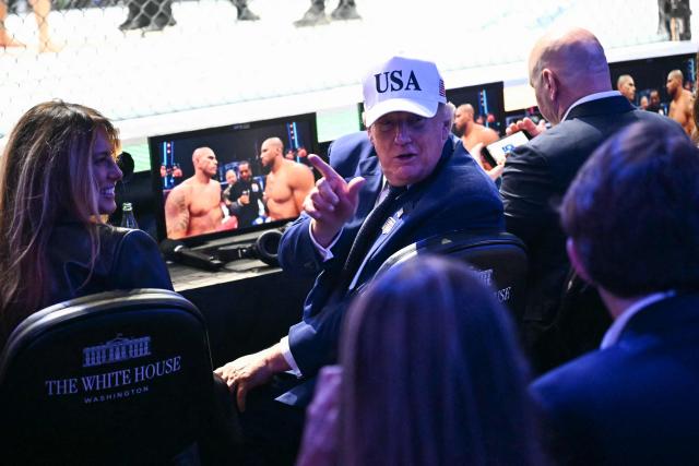 US President Donald Trump sits with First Lady Melania Trump during the "UFC Freedom 250" mixed martial arts event on the South Lawn of the White House in Washington, DC, June 14, 2026. (Photo by Kent NISHIMURA / AFP)