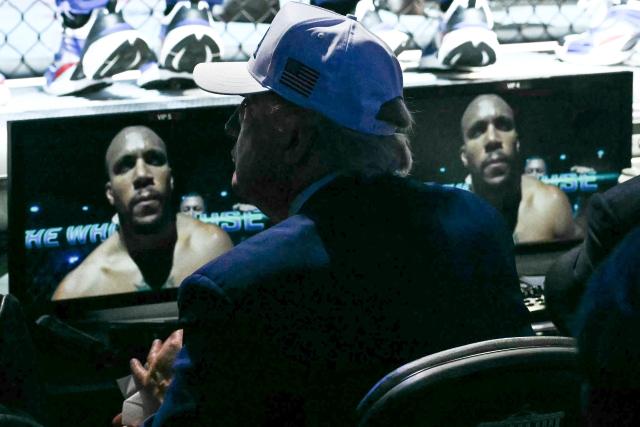 US President Donald Trump watches as France's Ciryl Gane is displayed on a monitor in front of him during the "UFC Freedom 250" mixed martial arts event on the South Lawn of the White House in Washington, DC, June 14, 2026. (Photo by Kent NISHIMURA / AFP)