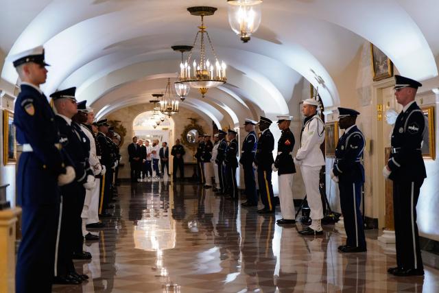 Members of the honour guard wait for fighters to walk through a White House hallway to their bout during UFC Freedom 250 in Washington, DC, on June 14, 2026. (Photo by Elizabeth Frantz / POOL / AFP)