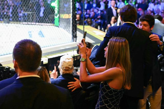Kai Trump, granddaughter of US President Donald Trump, takes a picture as she attends the "UFC Freedom 250" mixed martial arts event on the South Lawn of the White House in Washington, DC, June 14, 2026. (Photo by Kent NISHIMURA / AFP)