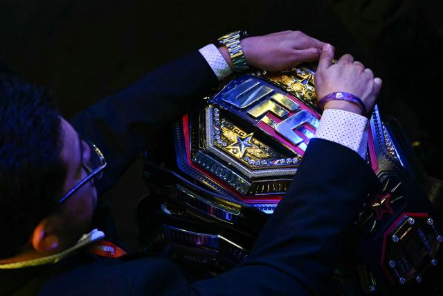 An official holds a UFC belt during the "UFC Freedom 250" mixed martial arts event on the South Lawn of the White House in Washington, DC, June 14, 2026. (Photo by Kent NISHIMURA / AFP)