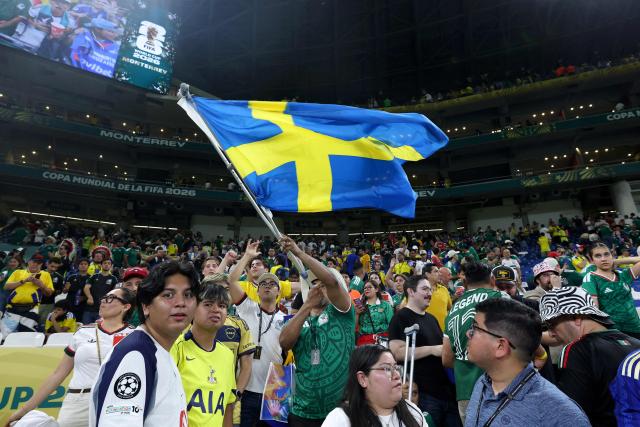 A Mexican fan waves a Swedish flag at the end of the 2026 World Cup Group F football match between Sweden and Tunisia at the Monterrey Stadium in Guadalupe on June 14, 2026.  (Photo by Julio Cesar AGUILAR / AFP)