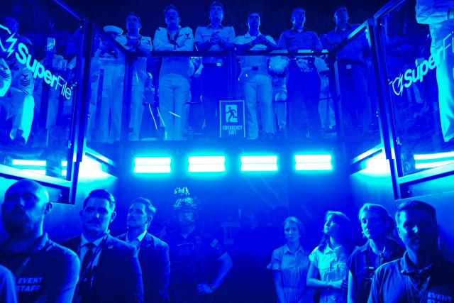 Members of the US military (top), event staff and security watch during the "UFC Freedom 250" mixed martial arts event on the South Lawn of the White House in Washington, DC, in the early morning hours of June 15, 2026. (Photo by Kent NISHIMURA / AFP)