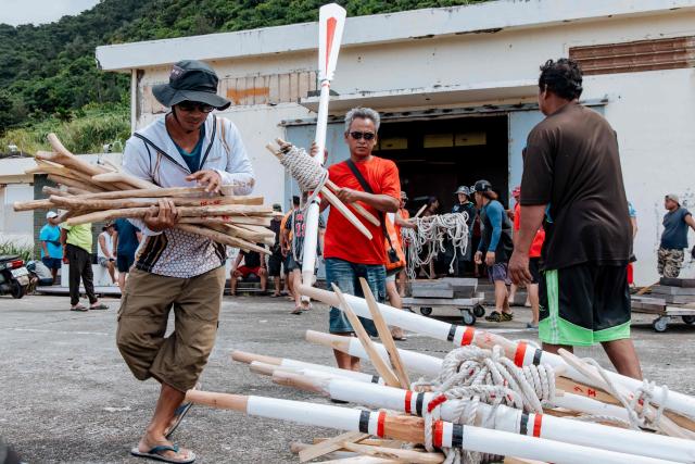 Crew members prepare to test-row a traditional wooden canoe called Ovayan (Golden Friendship) off Orchid island (or Lanyu island), southeastern Taiwan on June 14, 2026, on the eve of its planned voyage to Philippines' Batanes Islands. (Photo by CHENG Yu-chen / AFP)
