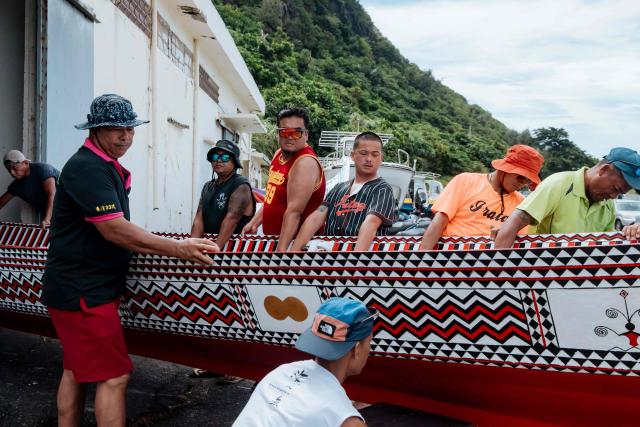 Crew members prepare to test-row a traditional wooden canoe called Ovayan (Golden Friendship) off Orchid island (or Lanyu island), southeastern Taiwan on June 14, 2026, on the eve of its planned voyage to Philippines' Batanes Islands. (Photo by CHENG Yu-chen / AFP)