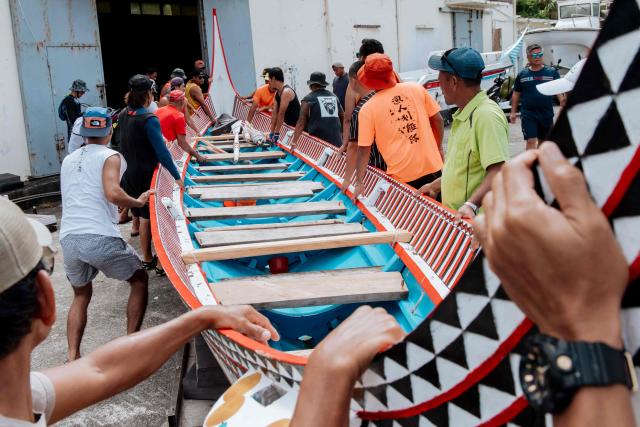 Crew members prepare and test-row a traditional wooden canoe called Ovayan (Golden Friendship) off Orchid island (or Lanyu island), southeastern Taiwan on June 14, 2026, on the eve of its planned voyage to Philippines' Batanes Islands. (Photo by CHENG Yu-chen / AFP)