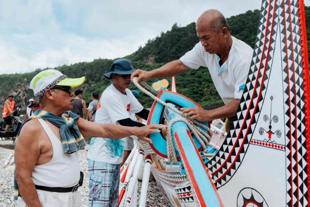 Crew members inspect a traditional wooden canoe called Ovayan (Golden Friendship) off Orchid island (or Lanyu island), southeastern Taiwan on June 14, 2026, on the eve of its planned voyage to Philippines' Batanes Islands. (Photo by CHENG Yu-chen / AFP)