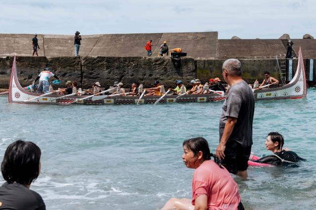 Crew members test-row a traditional wooden canoe called Ovayan (Golden Friendship) off Orchid island (or Lanyu island), southeastern Taiwan on June 14, 2026, on the eve of its planned voyage to Philippines' Batanes Islands. (Photo by CHENG Yu-chen / AFP)