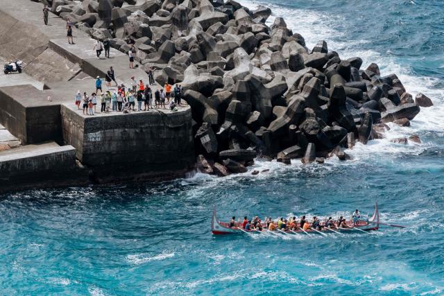 Crew members test-row a traditional wooden canoe called Ovayan (Golden Friendship) off Orchid island (or Lanyu island), southeastern Taiwan on June 14, 2026, on the eve of its planned voyage to Philippines' Batanes Islands. (Photo by CHENG Yu-chen / AFP)