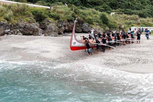 The Tao (Yami) indigenous rowers launch a traditional wooden canoe called Ovayan (Golden Friendship) for its voyage to Philippines' Batanes Islands, along the coastline at Orchid island (or Lanyu island), southeastern Taiwan on June 15, 2026. (Photo by CHENG Yu-chen / AFP)