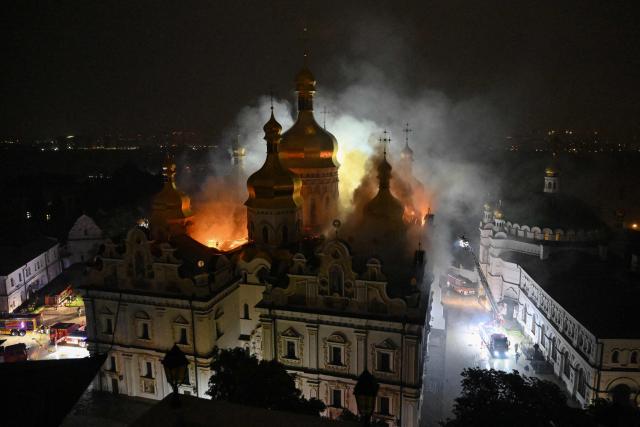 Smoke and fire rises from the Dormition Cathedral in the Orthodox complex of the Kyiv Pechersk Lavra following a Russian missile strike on the Ukrainian capital Kyiv on June 15, 2026, amid the Russian invasion in Ukraine. Russia fired a barrage of missiles at several major Ukrainian cities, setting Kyiv's historic Dormition Cathedral on fire and killing nine, while Ukraine strikes claimed three lives south of Moscow. (Photo by Genya SAVILOV / AFP)