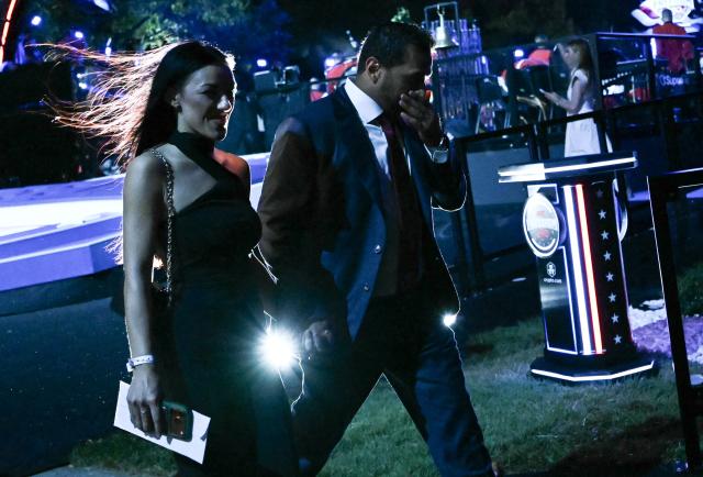 FBI director Kash Patel and singer Alexis Wilkins leave at the conclusion of the "UFC Freedom 250" mixed martial arts event on the South Lawn of the White House in Washington, DC, early morning on June 15, 2026. (Photo by Brendan SMIALOWSKI / AFP)