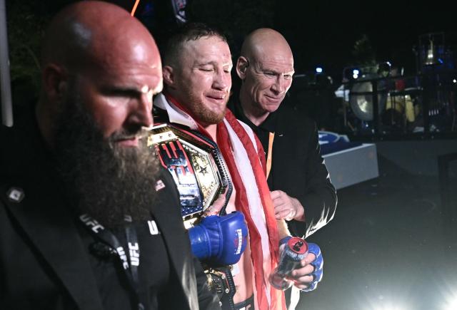 Mixed martial artist US's Justin Gaethje (C) leaves after defeating Georgia’s Ilia Topuria in their lightweight title bout during the "UFC Freedom 250" mixed martial arts event on the South Lawn of the White House in Washington, DC, early morning on June 15, 2026. (Photo by Brendan SMIALOWSKI / AFP)
