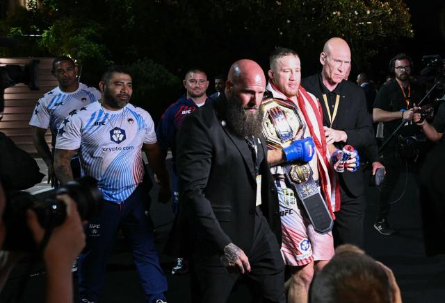 Mixed martial artist US's Justin Gaethje (C) leaves after defeating Georgia’s Ilia Topuria in their lightweight title bout during the "UFC Freedom 250" mixed martial arts event on the South Lawn of the White House in Washington, DC, early morning on June 15, 2026. (Photo by Brendan SMIALOWSKI / AFP)