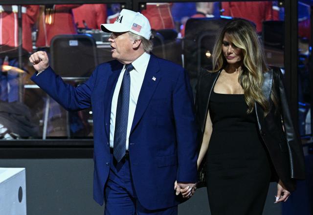 US President Donald Trump and US First Lady Melania Trump walk back to the White House after the "UFC Freedom 250" mixed martial arts event on the South Lawn of the White House in Washington, DC, early morning on June 15, 2026. (Photo by Brendan SMIALOWSKI / AFP)