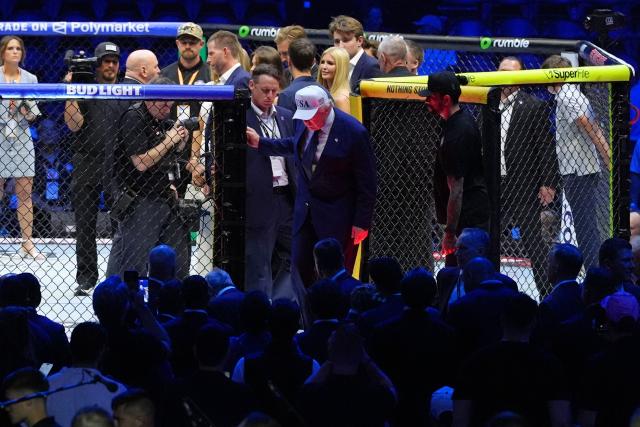 US President Donald Trump, wearing a white hat, leaves the Octagon after America's mixed martial artist Justin Gaethje defeated Georgia-Spain's mixed martial artist Ilia Topuria in a lightweight title bout during UFC Freedom 250 on the South Lawn of the White House, in Washington, DC, on June 15, 2026. (Photo by Jacquelyn Martin / POOL / AFP)