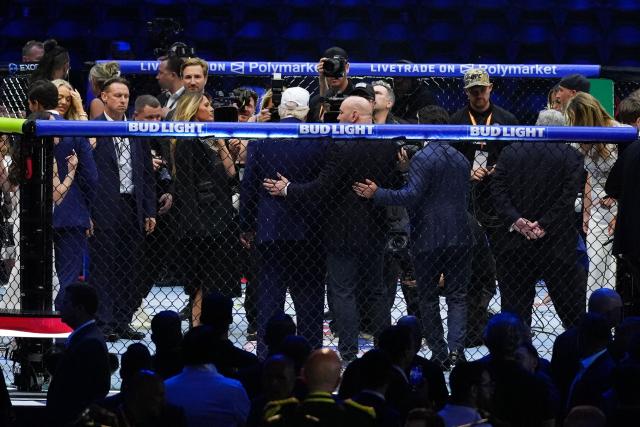 US President Donald Trump, wearing a white hat, and UFC President and CEO Dana White stand in the Octagon after America's mixed martial artist Justin Gaethje defeated Georgia-Spain's mixed martial artist Ilia Topuria in a lightweight title bout during UFC Freedom 250 on the South Lawn of the White House, in Washington, DC, on June 15, 2026. (Photo by Jacquelyn Martin / POOL / AFP)