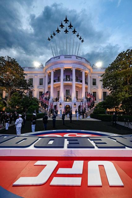 A 12-ship formation consisting of six US Air Force Thunderbirds F-16 Fighting Falcons and 6 US Navy Blue Angels fly over the White House as President Donald Trump and Dana White, president and CEO of the UFC, arrive for an Ultimate Fighting Championship match in Washington, DC, on June 14, 2026. (Photo by Kenny Holston/The New York Times / POOL / AFP)