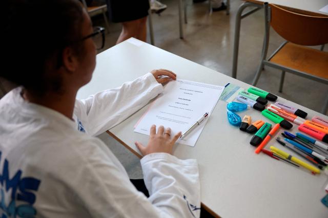 A student reads the exam paper as a 4 hours philosophy dissertation kicks off the French general baccalaureat exam for getting into university, at Louis Armand high school in Nogent-sur-Marne on June 15, 2026. More than 700,000 candidates across France take the 2026 session of the Baccalaureat or "bac", the secondary school diploma required for access to higher education, with written exams running from June 15 to 18 and oral examinations through early July. (Photo by SIMON WOHLFAHRT / AFP)