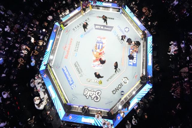 Brazil's mixed martial artist Alex Pereira, far right, is attended to, as France's mixed martial artist Ciryl Gane lays in the center of the ring during UFC Freedom 250 on the South Lawn of the White House, in Washington, DC, on June 15, 2026. (Photo by Alex Brandon / POOL / AFP)