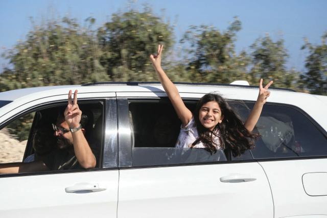 Displaced residents flash the V-sign as they cross the Bourj Rahal bridge on their way to their village in southern Lebanon on June 15, 2026. The United States and Iran said they reached a deal to end the Middle East war on all fronts including Lebanon, and reopen the vital Strait of Hormuz, but offered little indication on the thorny question of Tehran's nuclear programme. Washington and Islamabad said the agreement was to be signed on June 19 in Switzerland, signalling what would be a major breakthrough to ending months of war that have taken thousands of lives and roiled energy markets. (Photo by Kawnat HAJU / AFP) / 