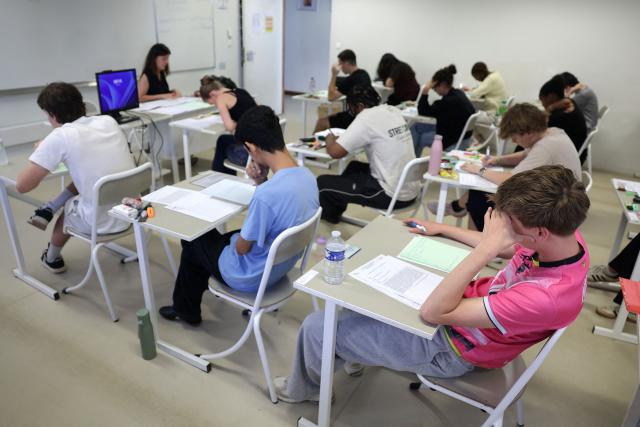 Students start working as a 4 hours philosophy dissertation kicks off the French general baccalaureat exam for getting into university, at Bellevue high school, in Toulouse, south-western France on June 15, 2026. More than 700,000 candidates across France take the 2026 session of the Baccalaureat or "bac", the secondary school diploma required for access to higher education, with written exams running from June 15 to 18 and oral examinations through early July. (Photo by Valentine CHAPUIS / AFP)