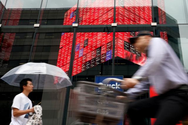 An electronic quotation board displays the Nikkei 225 stock prices on the Tokyo Stock Exchange in Tokyo on June 15, 2026. (Photo by Kazuhiro NOGI / AFP)