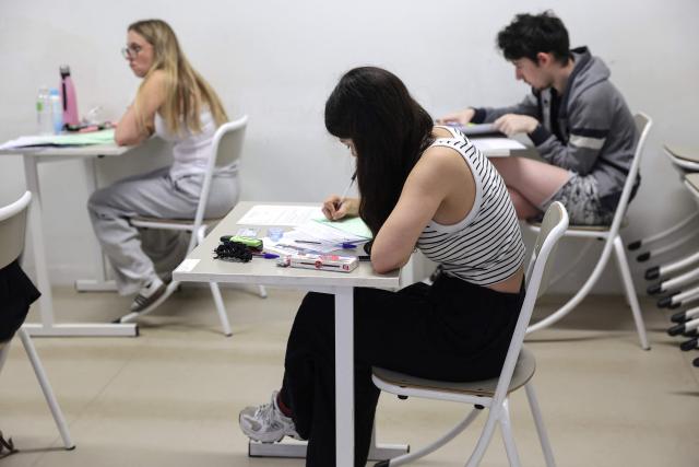 Students start working as a 4 hours philosophy dissertation kicks off the French general baccalaureat exam for getting into university, at Bellevue high school, in Toulouse, south-western France on June 15, 2026. More than 700,000 candidates across France take the 2026 session of the Baccalaureat or "bac", the secondary school diploma required for access to higher education, with written exams running from June 15 to 18 and oral examinations through early July. (Photo by Valentine CHAPUIS / AFP)