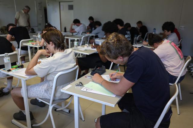 Students start working as a 4 hours philosophy dissertation kicks off the French general baccalaureat exam for getting into university, at Bellevue high school, in Toulouse, south-western France on June 15, 2026. More than 700,000 candidates across France take the 2026 session of the Baccalaureat or "bac", the secondary school diploma required for access to higher education, with written exams running from June 15 to 18 and oral examinations through early July. (Photo by Valentine CHAPUIS / AFP)